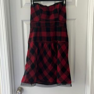 Plaid strapless mini dress with mesh detailing on neckline, zipper, hem. Size 6.
